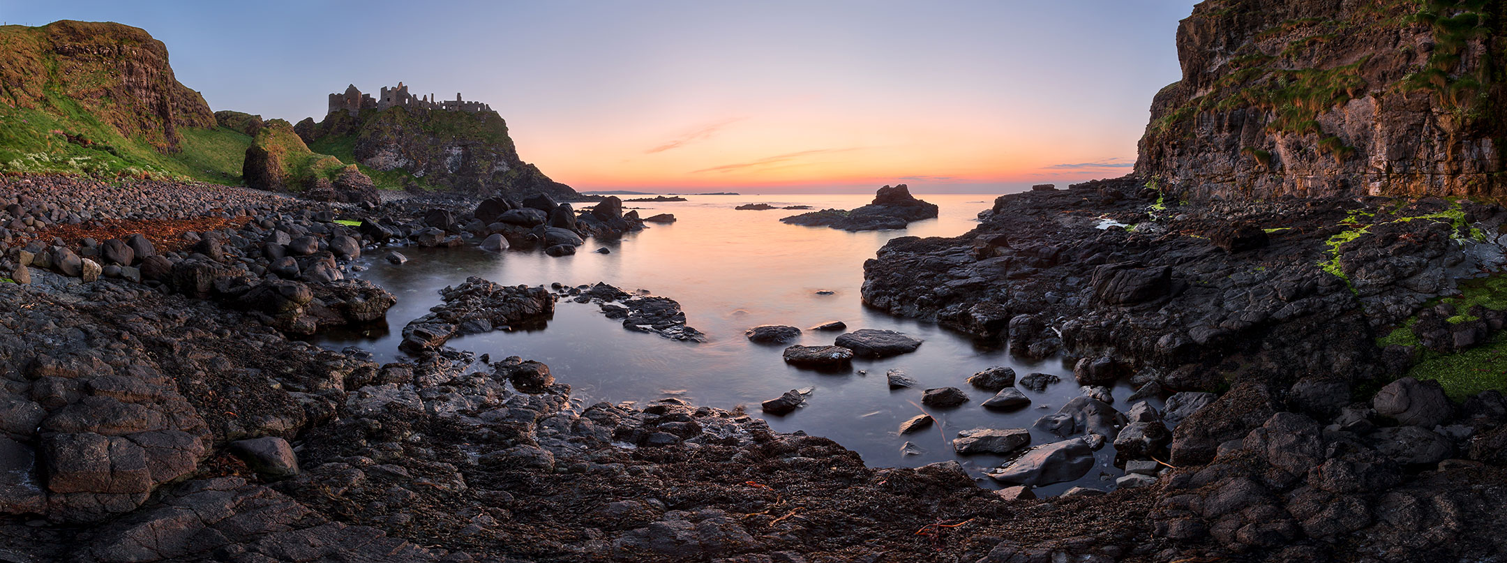 Panorama of Dunluce Castle at dusk, County Antrim, Northern Ireland