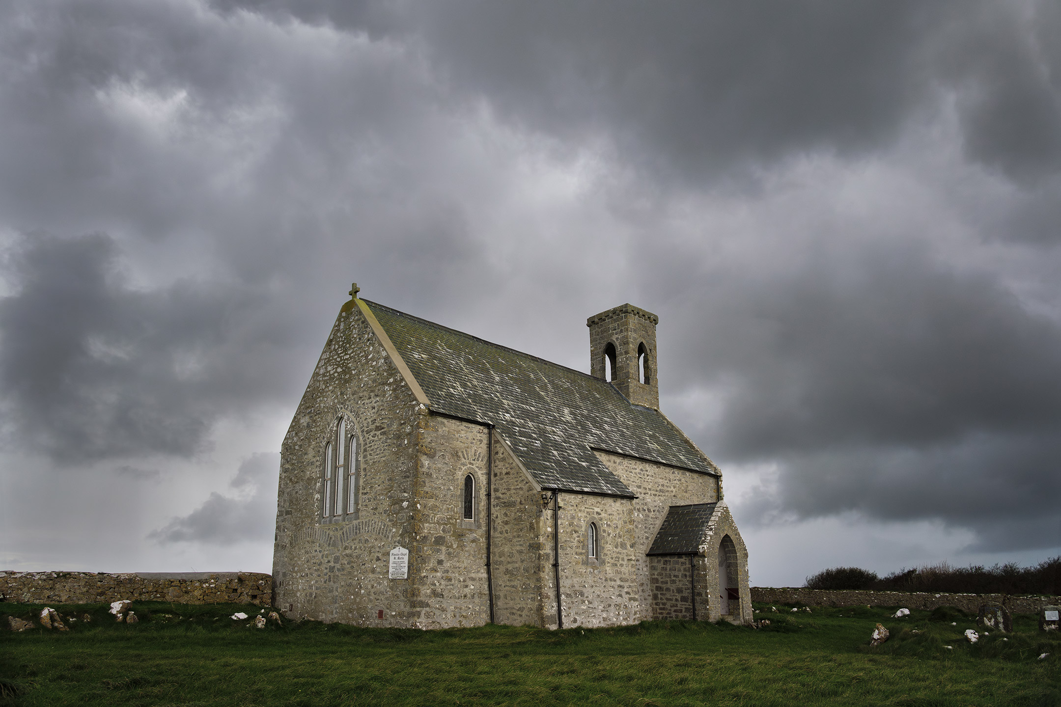 Brooding clouds amass over Flimstone Chapel in Pembrokeshire, Wales