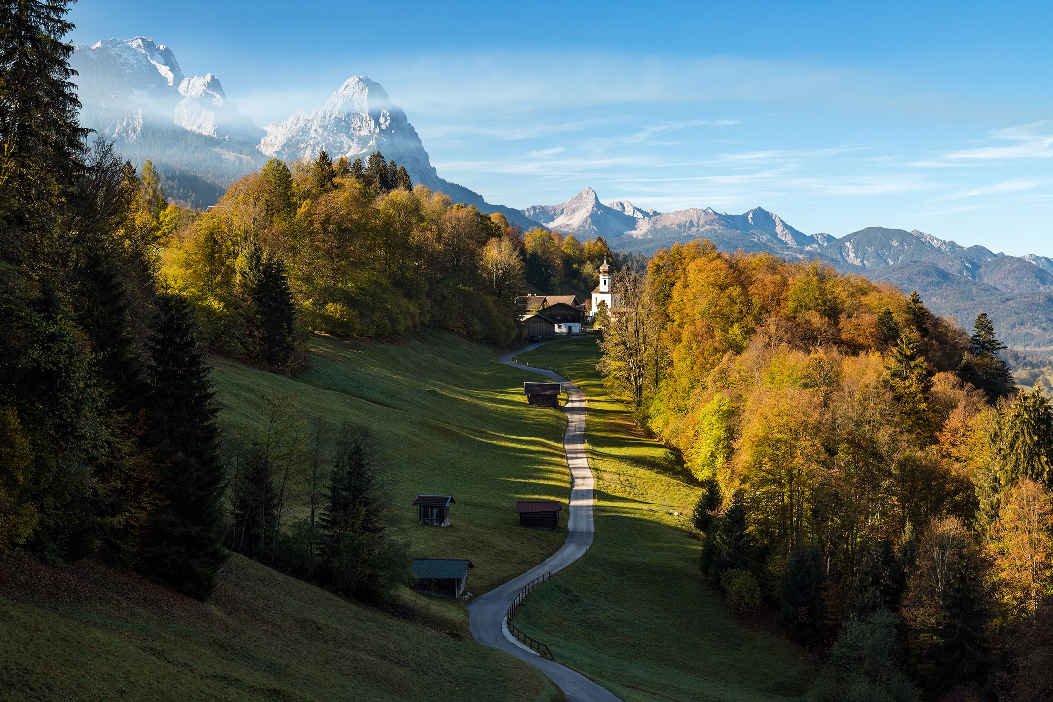 Kirche St Anna nestled amongst the autumn trees of the Bavarian Alps, Wamberg, Germany