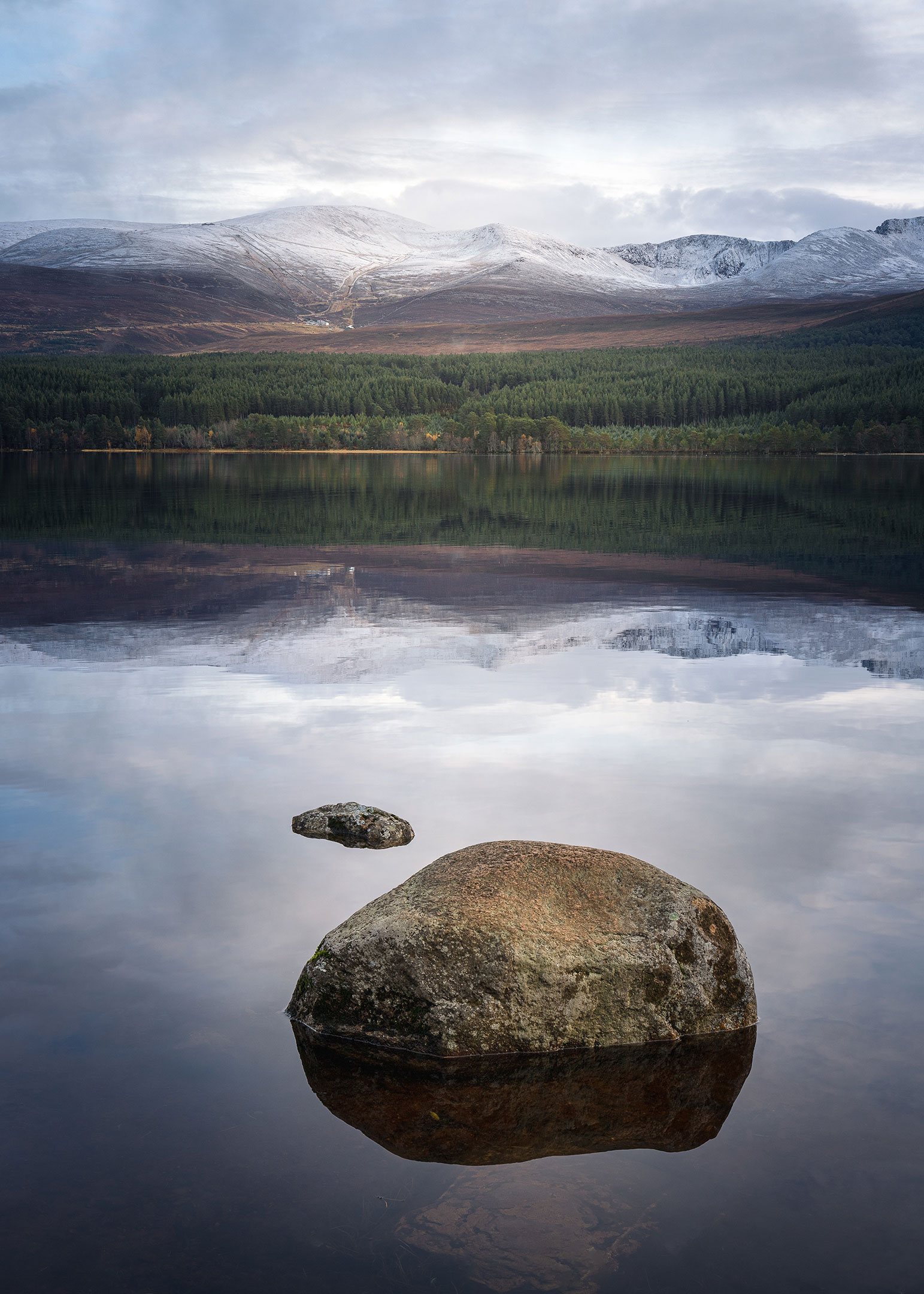 A calm Loch Morlich after snowfall, Cairngorm Mountains, Scotland