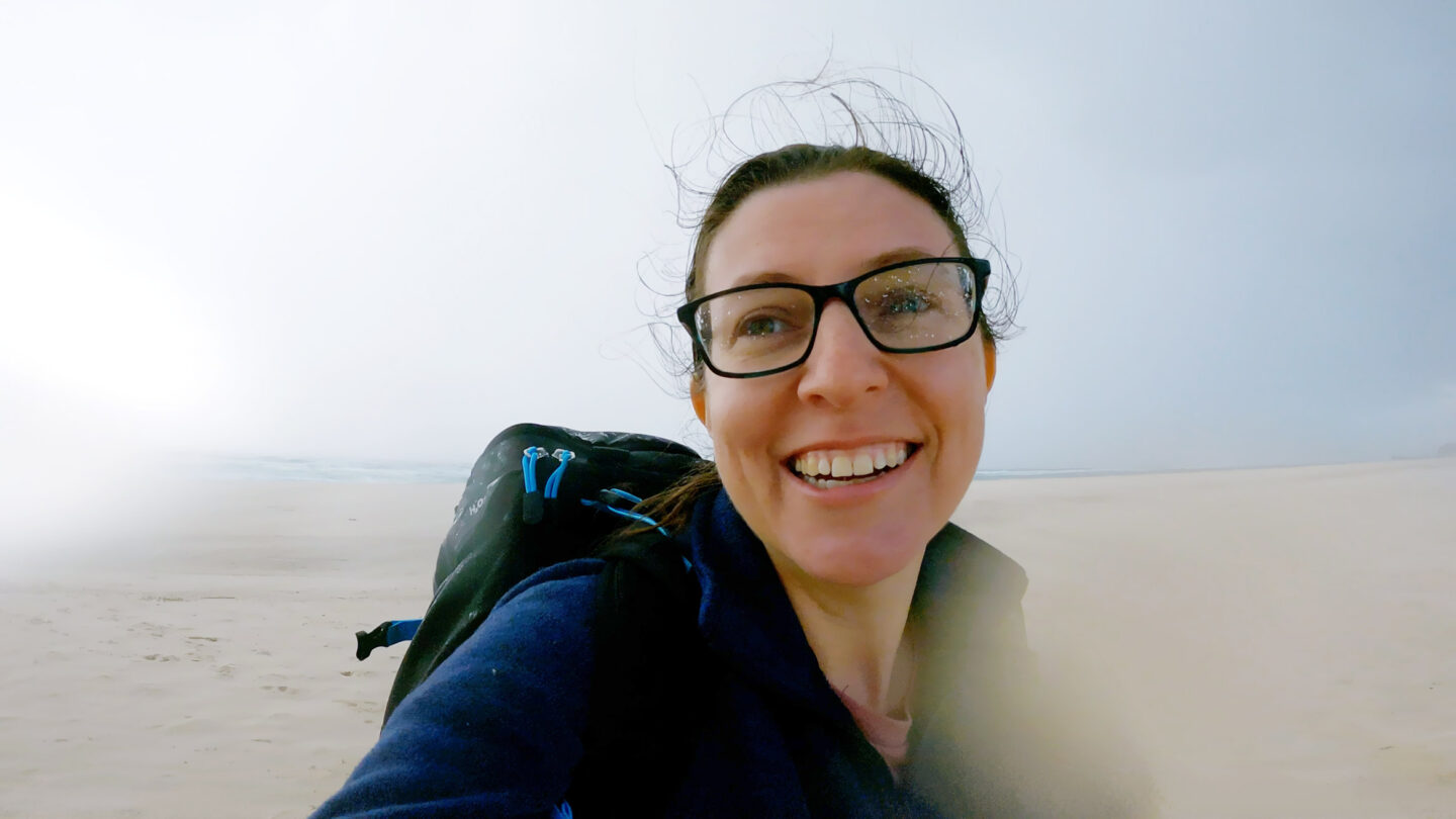 Lisa on the beach in the wind and rain