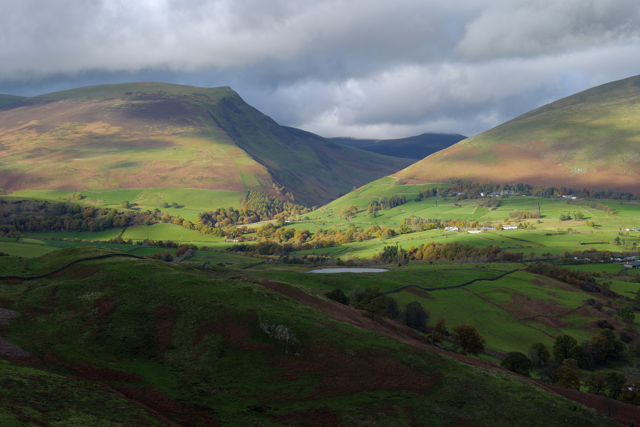 Patches of light bathe Lonescale Fell and Blencathra in the Lake District, England